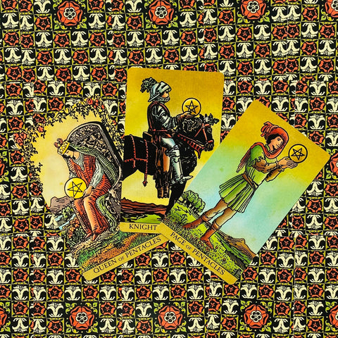 tarot kortos Rider‑Waite stiliaus: trys Pentaklių kortos (Karalienė, Riteris, Pagenas) išdėstytos įstrižai ant dekoratyvaus rašto fono
