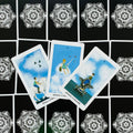 Tarot kortos – trys swords rūšies karališkos kortos su mėlyno dangaus iliustracijomis, išdėstytos ant juodo mandalos fono