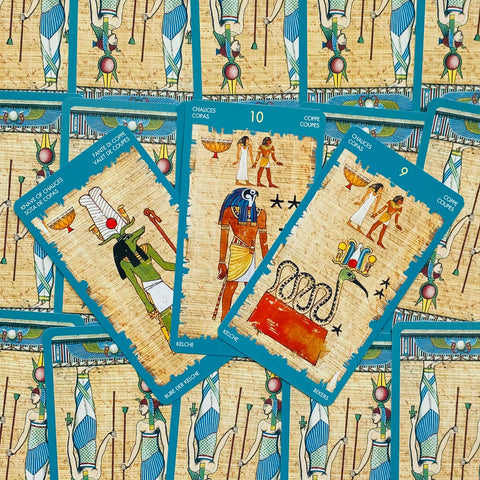 Tarot kortos egiptietiško dizaino su mėlynomis kraštinėmis, trijų kortų išklotinė ant papiruso fono, rodoma priekinė pusė