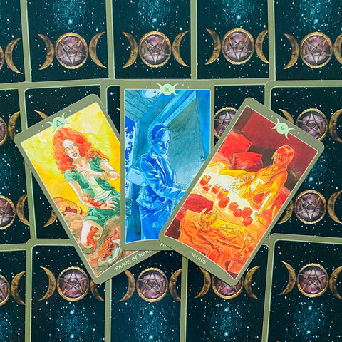 tarot kortos trijų kortų skaitymas: ryškios iliustruotos priekinės kortos (mėlyna, geltona, raudona) ant naktinio mėnulio rašto nugarėlių