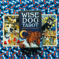 tarot kortos Wise Dog — tamsiai mėlyna dėžutė su šuns iliustracija ir mėnuliu, centre ant mėlyno kaulų rašto fono tarp dviejų kortų