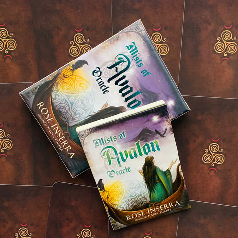 Mists of Avalon oracle kortų rinkinys su Rose Inserra viršeliu, dvi dėžutės ant raudonų kortų nugarėlių, matomas iš viršaus