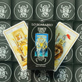 Lo Scarabeo tarot kortos juodoje dėžutėje, centre dėžutės priekinis viršelis ir dvi atverstos kortos šone