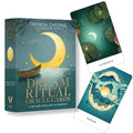 Orakulų kortos Dream Ritual (Theresa Cheung) mėlyno‑žalsvos dėžutės su valtimi ir dvi kortos, atidengiančios mėnulio iliustracijas