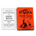 Burtažaidžių kortos Gypsy Witch: oranžinė dėžutė su raganiška figūra ir šalia matomas pridėtinis instrukcijų lapas