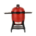Kamado grilis Kamado Joe raudonas ant vežimėlio su ratukais ir išskleistomis šoninėmis lentynėlėmis, matomas iš priekio