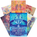 Orakulinės kortos Mystical Journey (Tennessee Charpentier) — mėlyna dėžutė ir fanuotos ryškios iliustruotos kortos, matomas priekinis viršelis