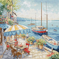 Siuvinėjimo rinkinys krantinės kavinė prie jūros su mėlyna valtimi ir geltonu skėčiu, 30×30 cm detalizuota scena