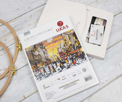 Siuvinėjimo rinkinys Lucas Gold Collection "Christmas Shopping" – pakuotė parodyta su siūlų dėžute ir mediniais lankais, matoma komplektacija