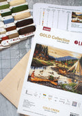 Kryželių rinkinys Gold Collection "Gold Creek" su drobe, spalvotais siūlais ir schema ežero bei kanojų motyvu