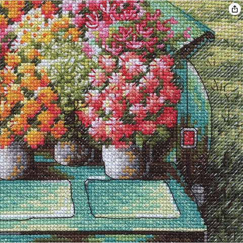 kryželių rinkinys – arti užfiksuota siūlių faktūra ir sodrios koralų bei geltonų gėlių spalvos ant žydro furgono