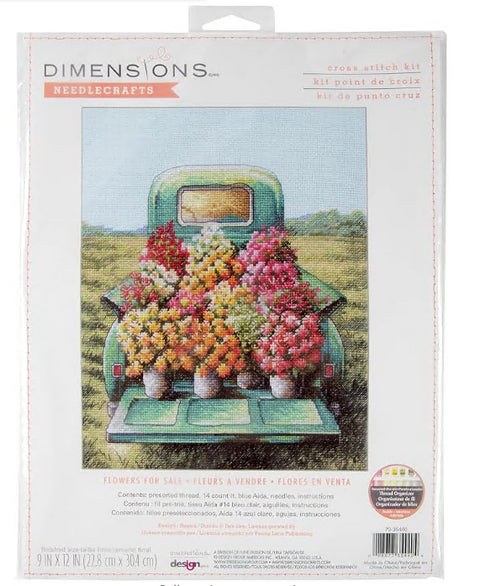 Kryželių rinkinys Dimensions pakuotės priekinėje — turkio spalvos sunkvežimis su ryškiomis gėlėmis, 23×30 cm dizainas