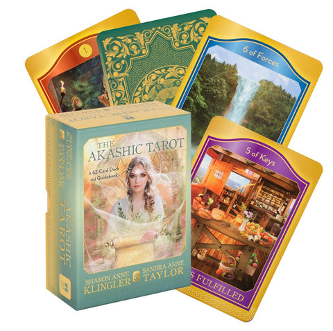 Akashic tarot kortos dėžutėje su priedu — 62 kortų komplektas ir keli atversti kortų pavyzdžiai su auksinėmis kraštinėmis